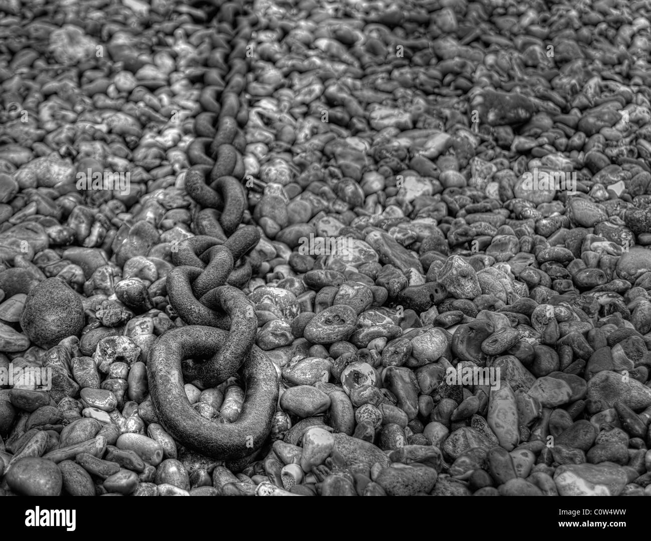 old chain on a pebble beach Stock Photo