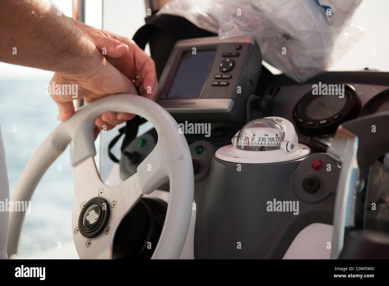 Man driving boat yacht "mid section" close Stock Photo - Alamy