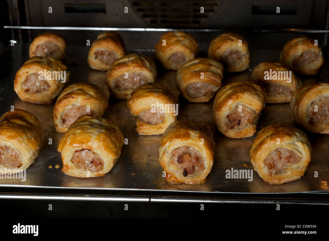 Homemade sausage rolls in the oven Stock Photo Alamy