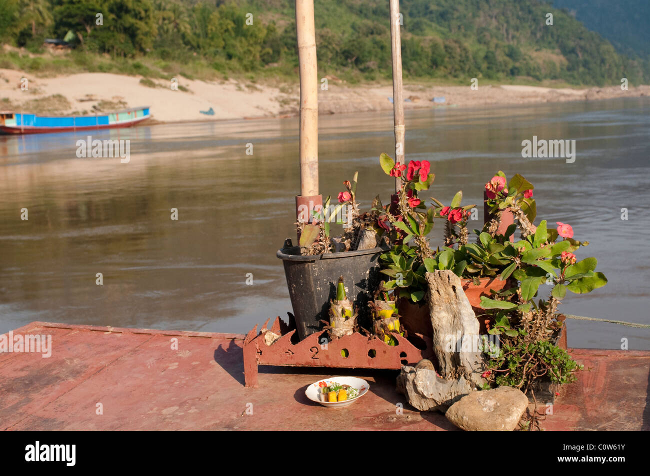Front of the boat with flowerpots on the River Mekong, Laos Stock Photo