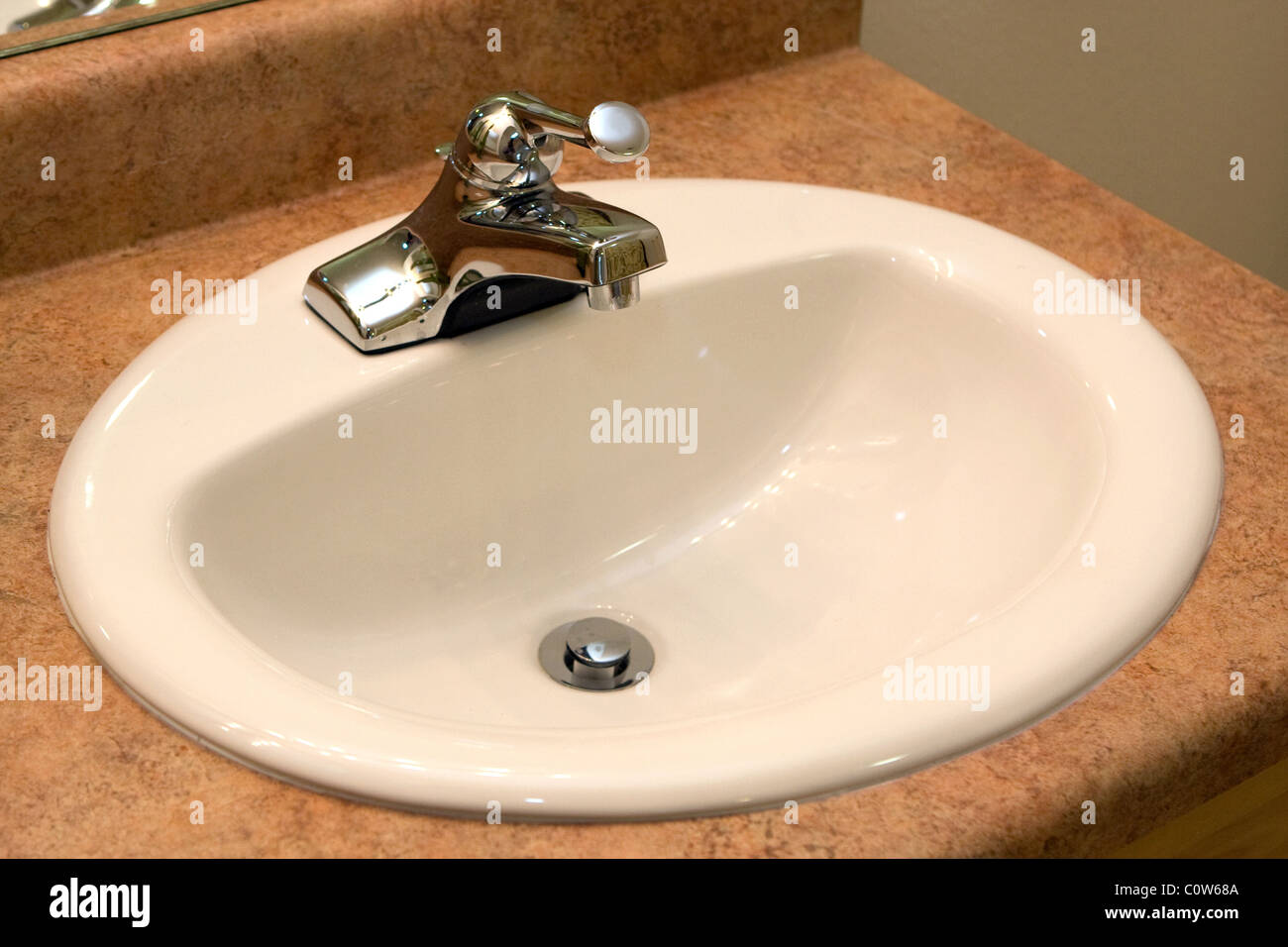 A new bathroom sink and faucet in a formica vanity Stock Photo Alamy