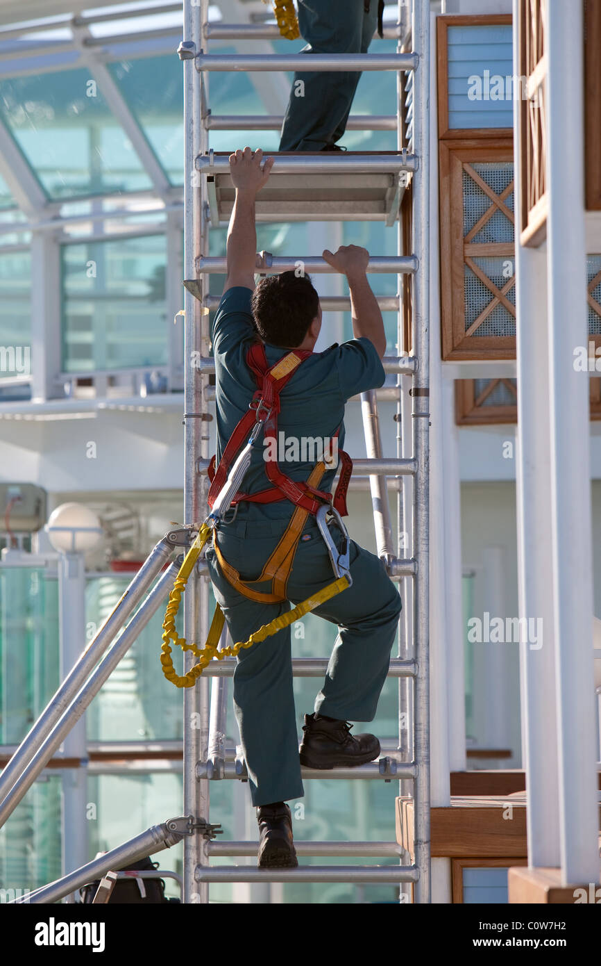 use of safety harnesses on board ship during repairs Stock Photo Alamy