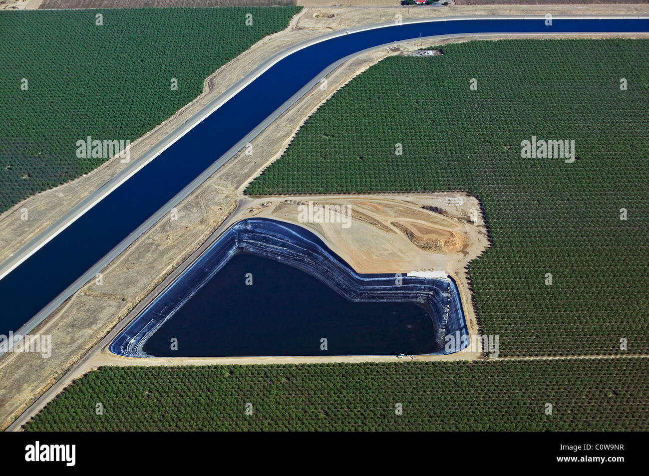 aerial view above aqueduct artificial lined irrigation pond central valley California Stock Photo