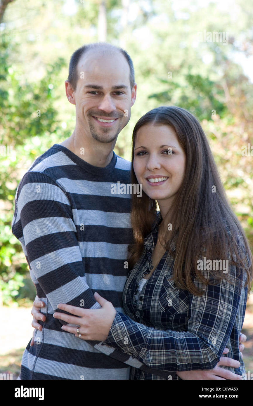 Young married couple pose during an outdoor photo session. Stock Photo