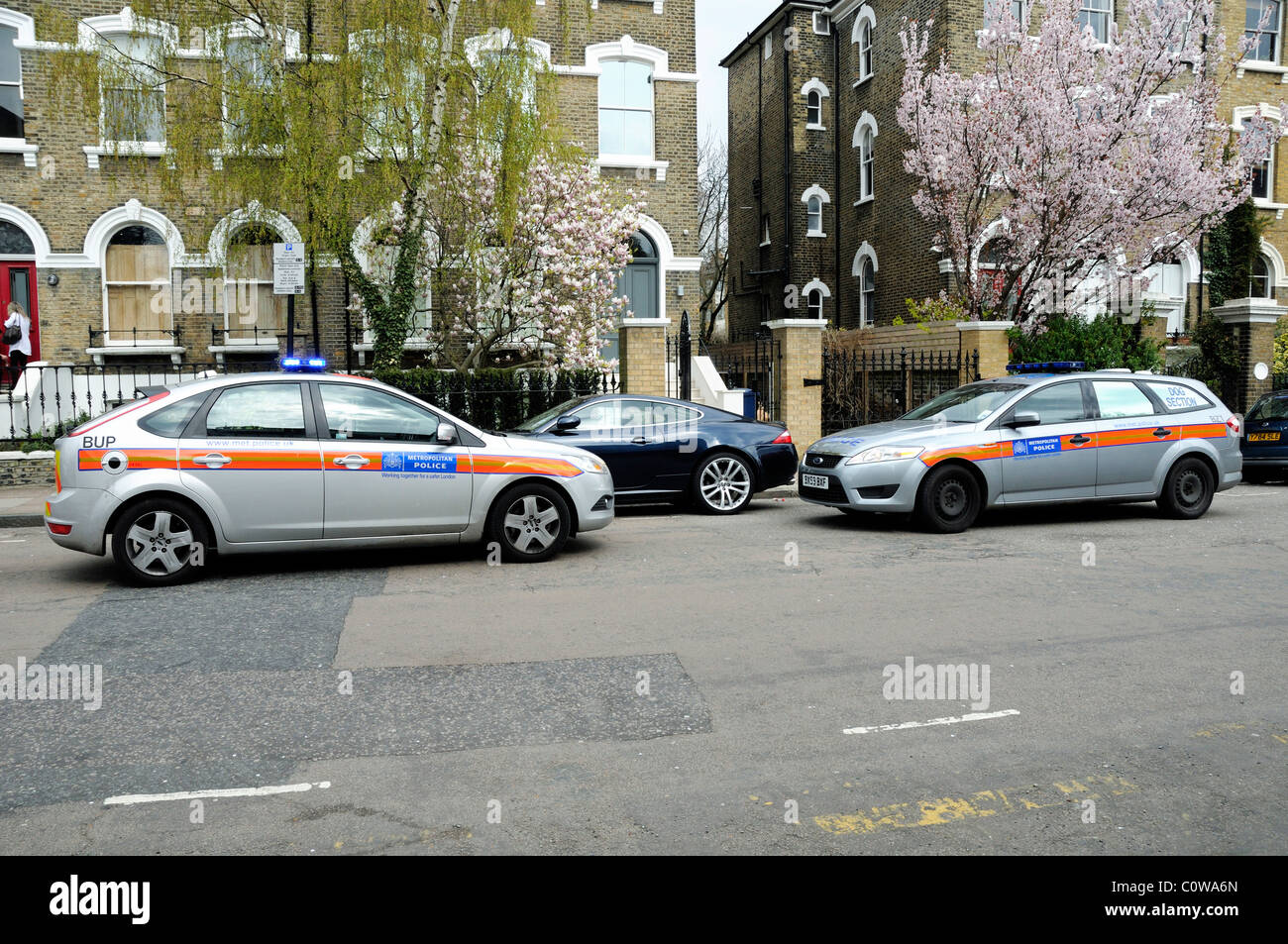 Two Metropolitan Police Cars facing each other attending an incident on Highbury Hill Islington London England UK Stock Photo