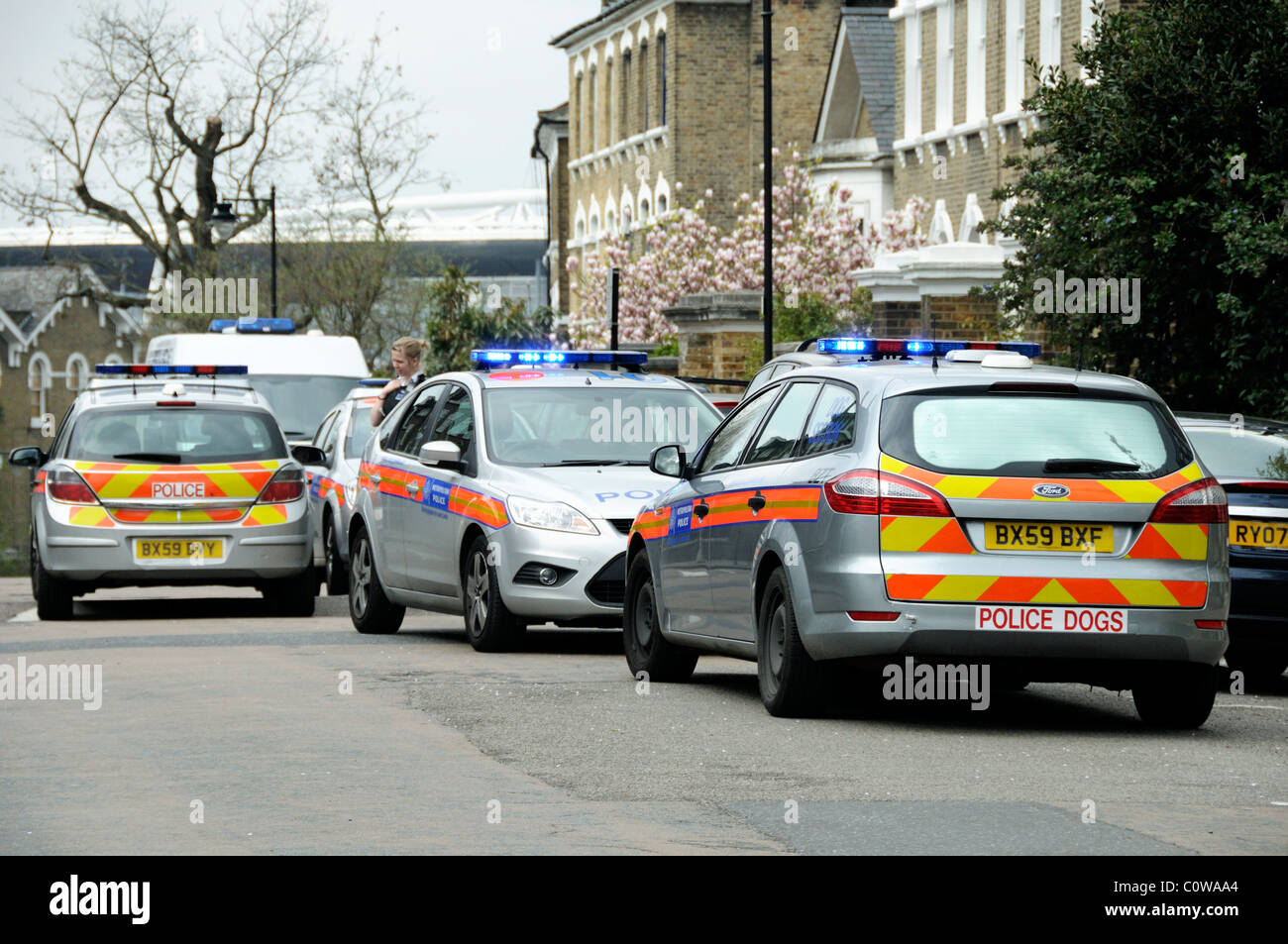Several Metropolitan Police Cars with female officer present attending an incident on Highbury Hill Islington London England UK Stock Photo