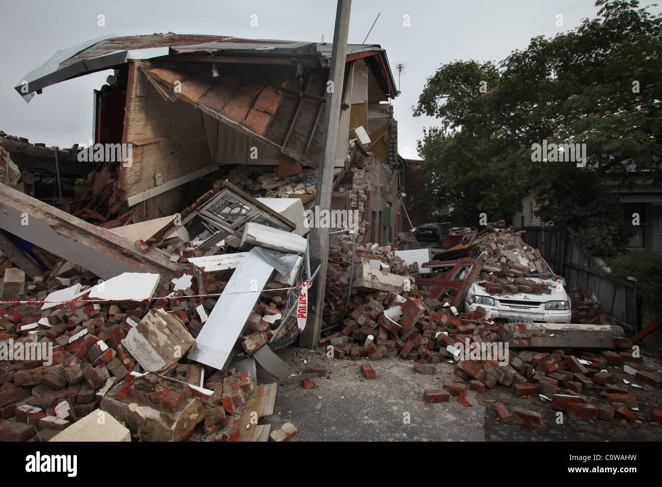 Cars parked beside a collapsed pharmacy on Bealey Avenue, Christchurch, New Zealand after the 6.3 magnitude earthquake Stock Photo