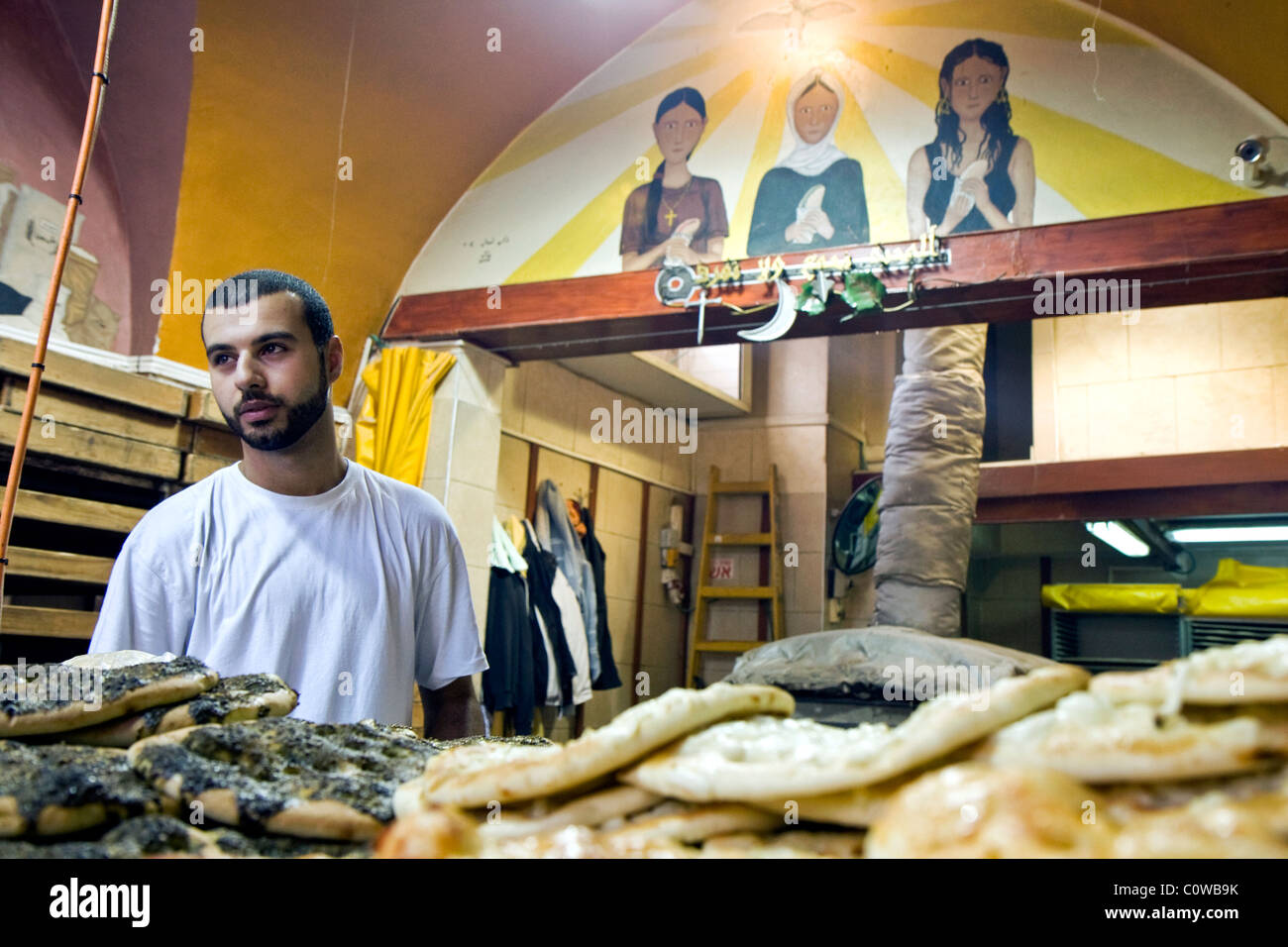 Man in a traditional Arab bakery in Wadi Nisnas in Haifa sells bread