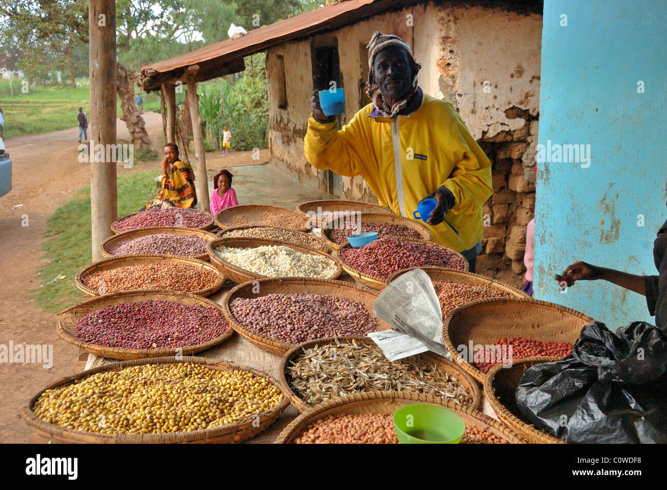 A man selling beans and grains in the town of Usa River near Arusha Tanzania Stock Photo