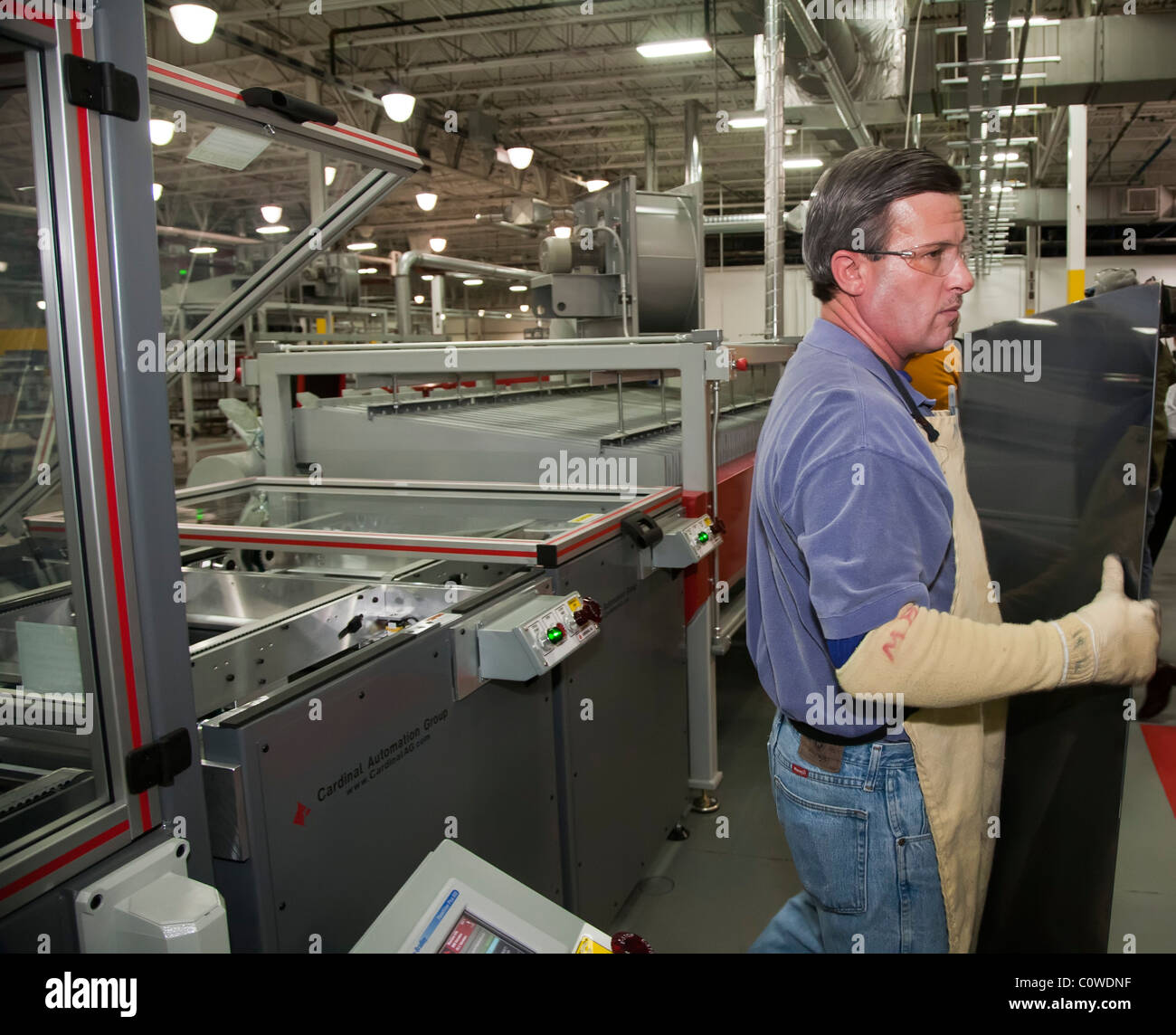 Perrysburg, Ohio - A worker handles a thin-film solar panel manufactured at WK Solar. Stock Photo