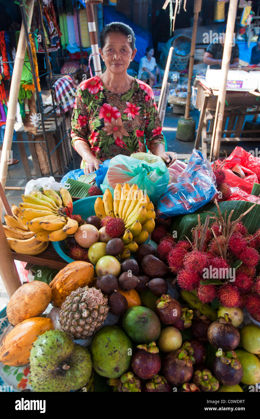 Woman selling tropical fruit in the public market in Ubud Bali Indonesia Stock Photo