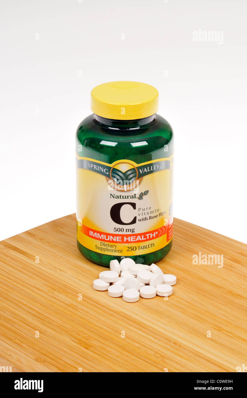Bottle of Spring Valley Vitamin C dietary supplement with tablets scattered Stock Photo