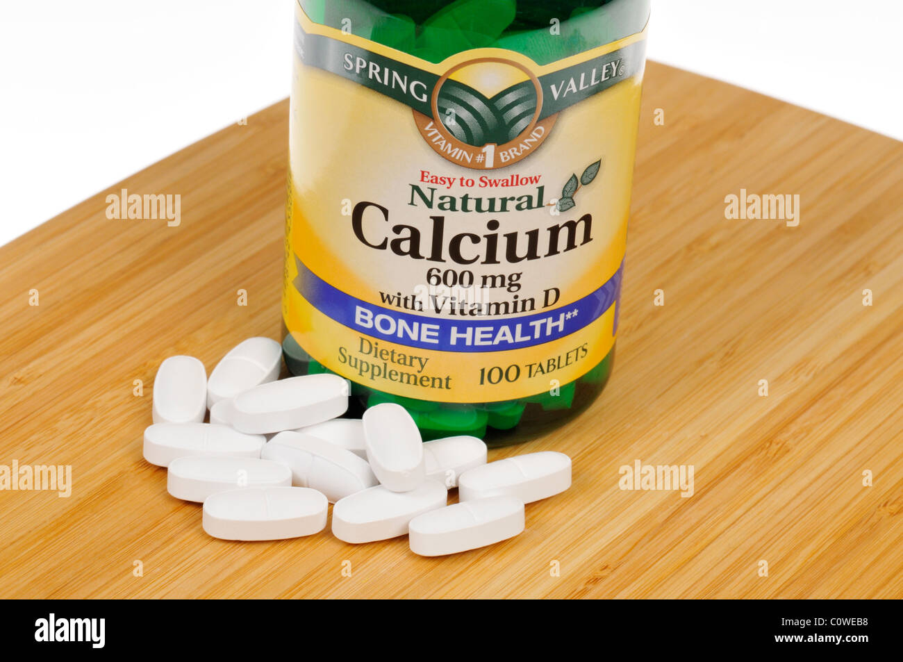 Bottle of Spring Valley Calcium with Vitamin D dietary supplement with tablets scattered. Stock Photo