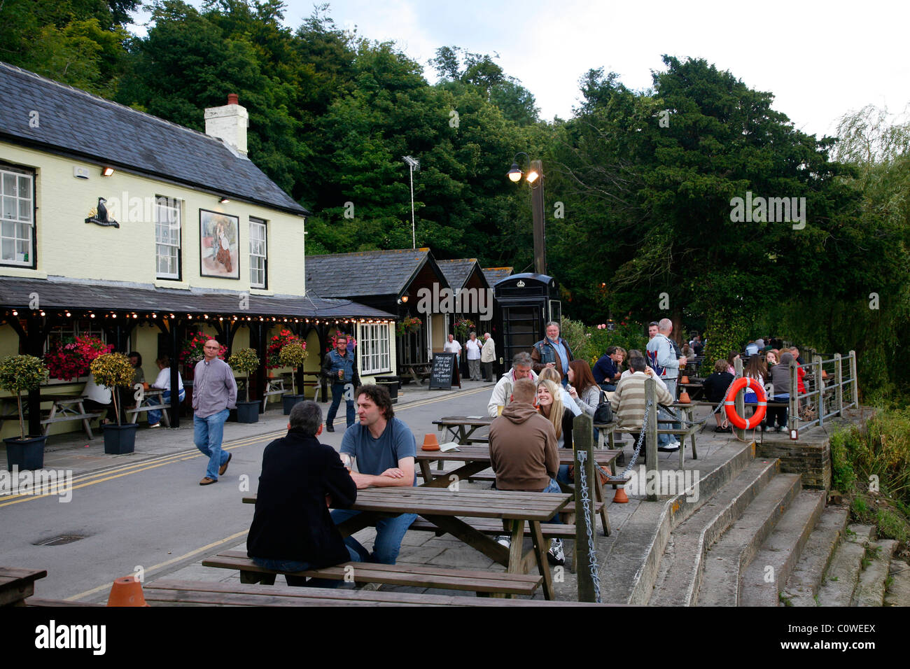 People sitting at the Black Rabbit bar along the river Arun in Arundell , England, UK. Stock Photo