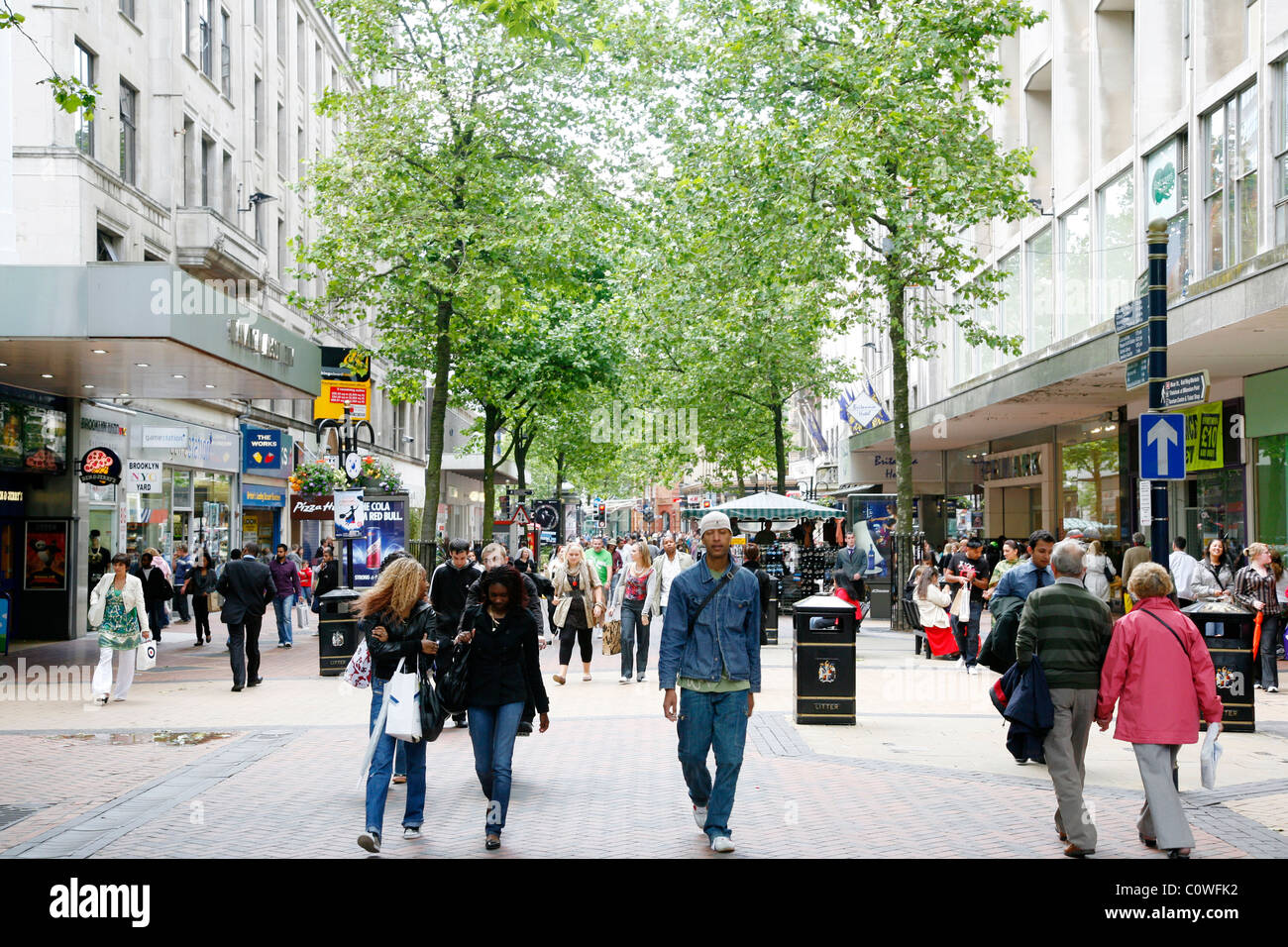 People walking down New Street, a pedestrian street with many shops. Birmingham, England, UK. Stock Photo