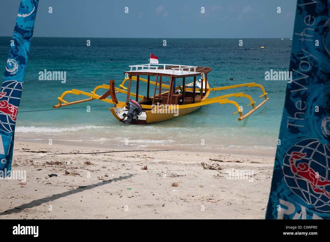 Brightly painted glass bottomed dive boat on the beach at Gili Trawangan a small island off Lombok, Indonesia Stock Photo