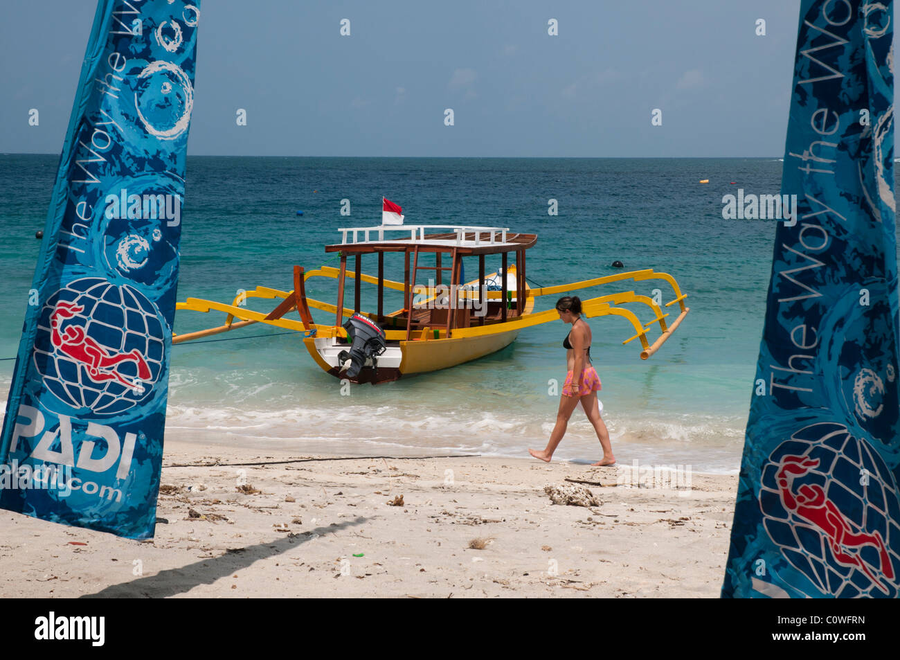 Brightly painted glass bottomed dive boat on the beach at Gili Trawangan a small island off Lombok, Indonesia Stock Photo