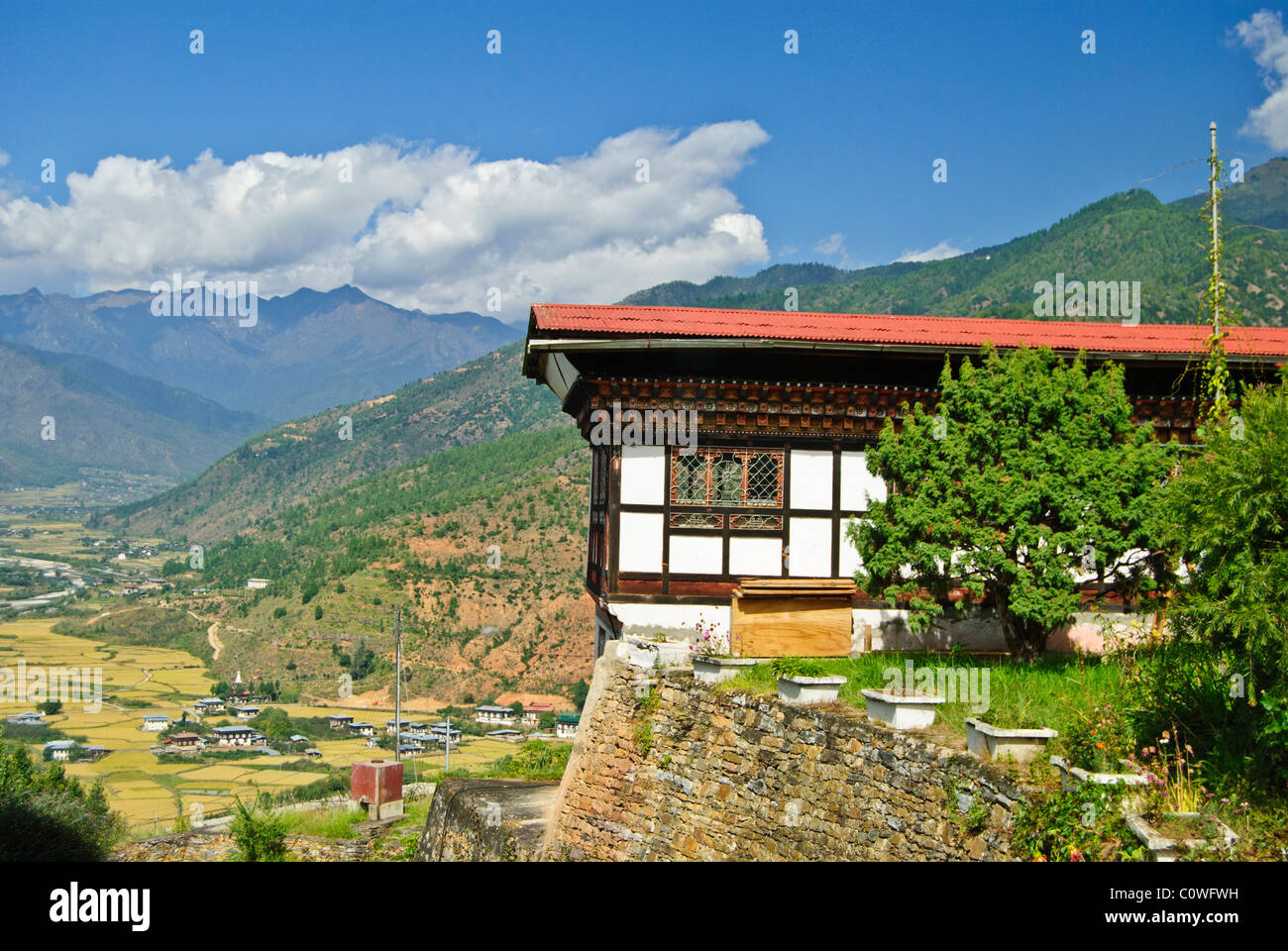Bhutanese building on the edge of the mountain in Paro Valley Stock Photo