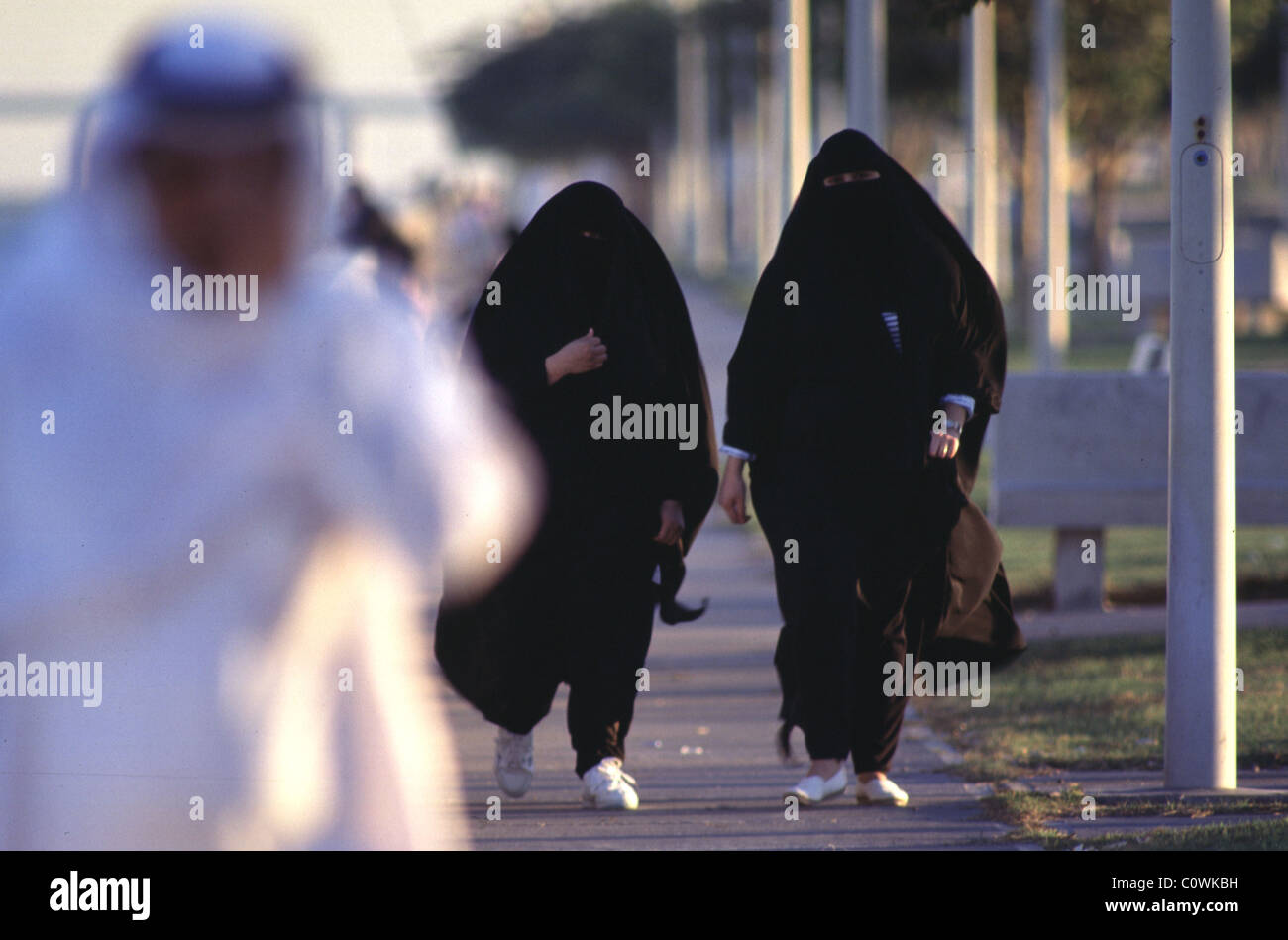 khobar, saudi arabia -- saudi women joggers in full saudi attire exercising on the city's main corniche. Stock Photo