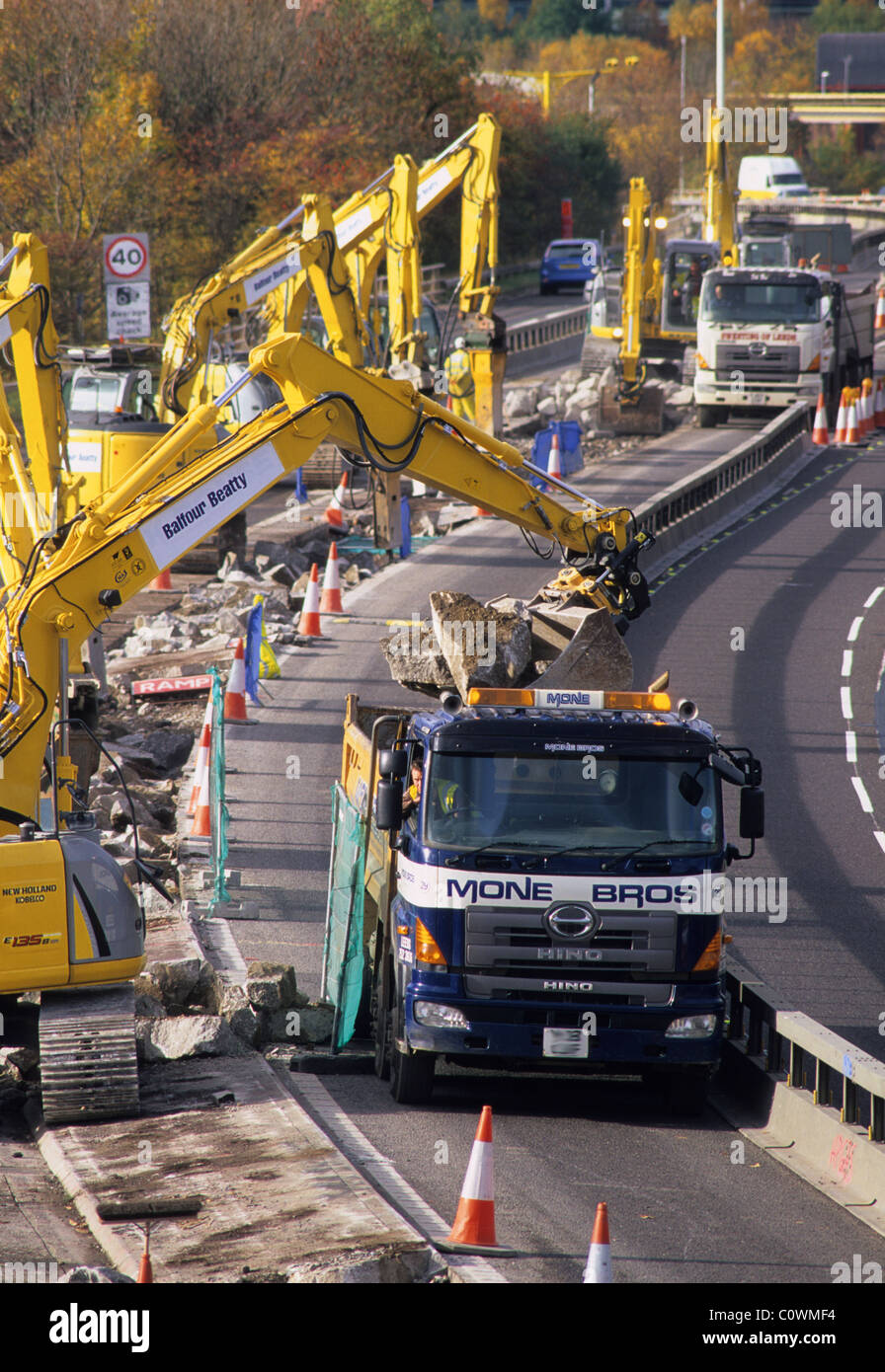 diggers at roadworks on the M621 motorway filling lorrys with rubble
