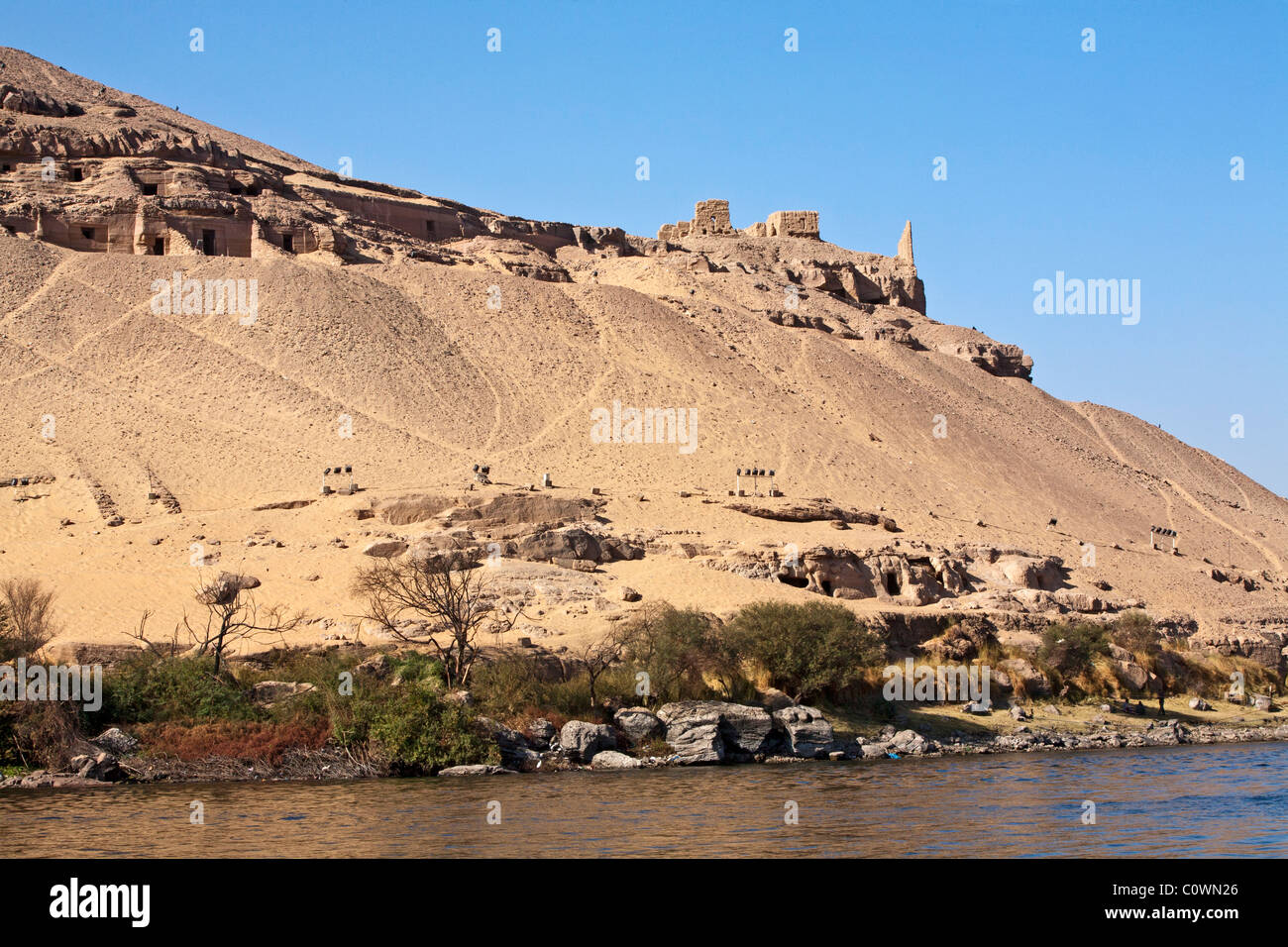 Egypt's Nobles Tombs are built into the sandstone cliffs on the Nile River near the city of Aswan Stock Photo