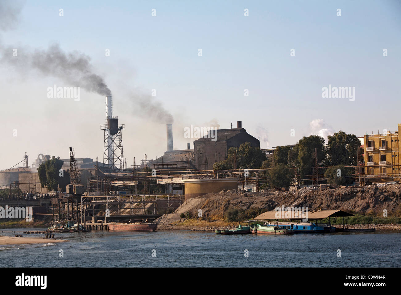 This Egyptian sugar cane processing plant on the Nile stays busy with sugar production year around Stock Photo