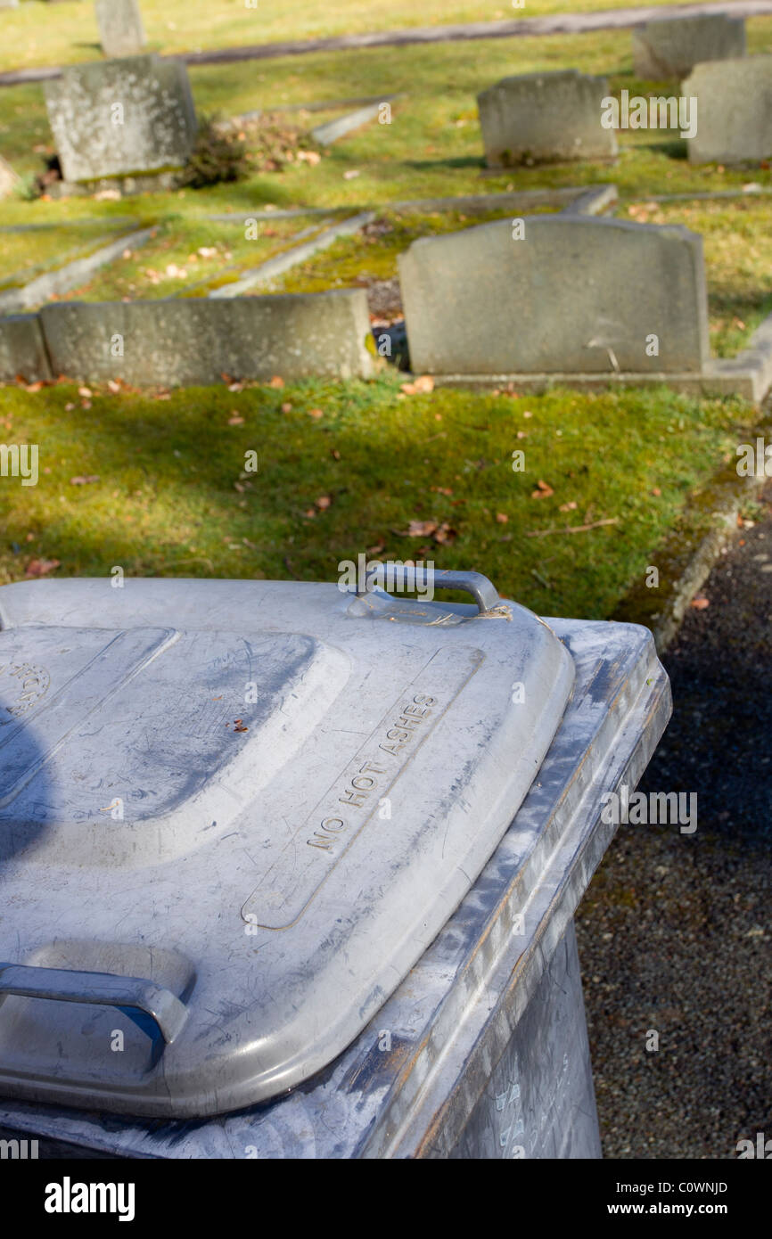 grave yard with head stones with wheelie Bins bin say 'NO HOT ASHES Stock Photo