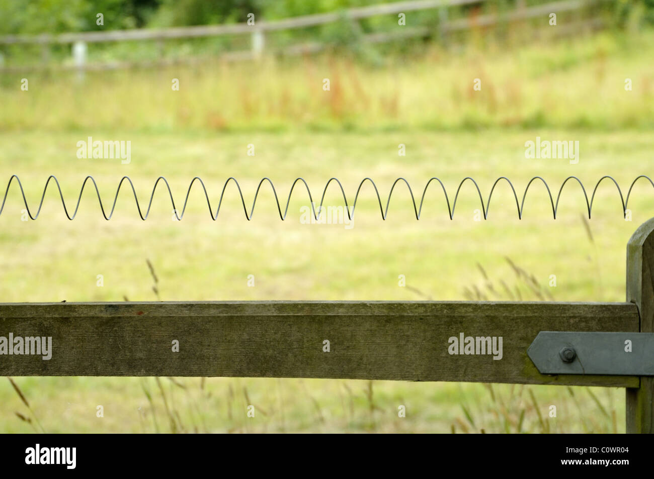 Electric wiring across a gate. Stock Photo