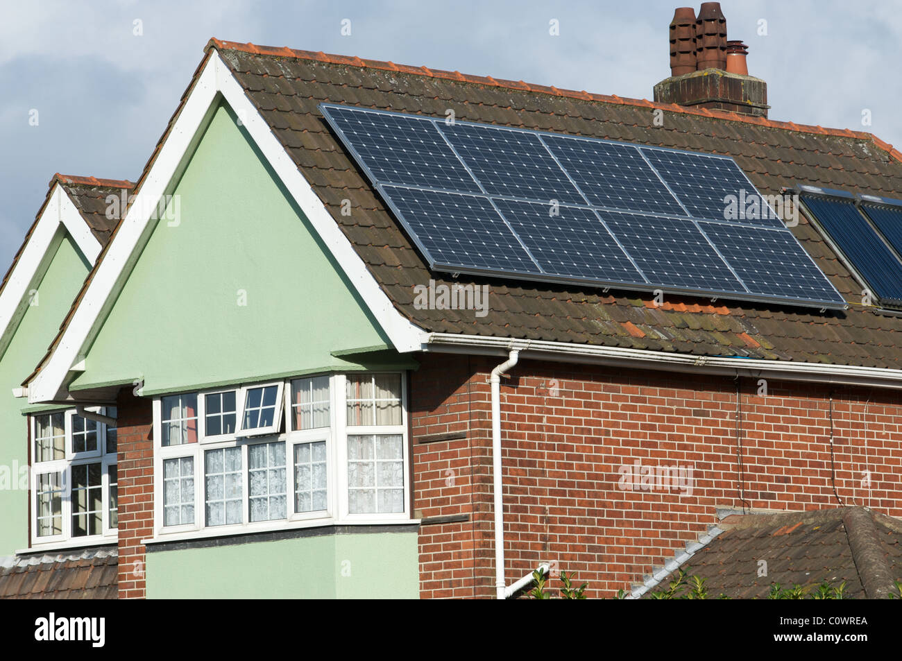 Solar panels fitted to roof of residential property in the UK. Stock Photo