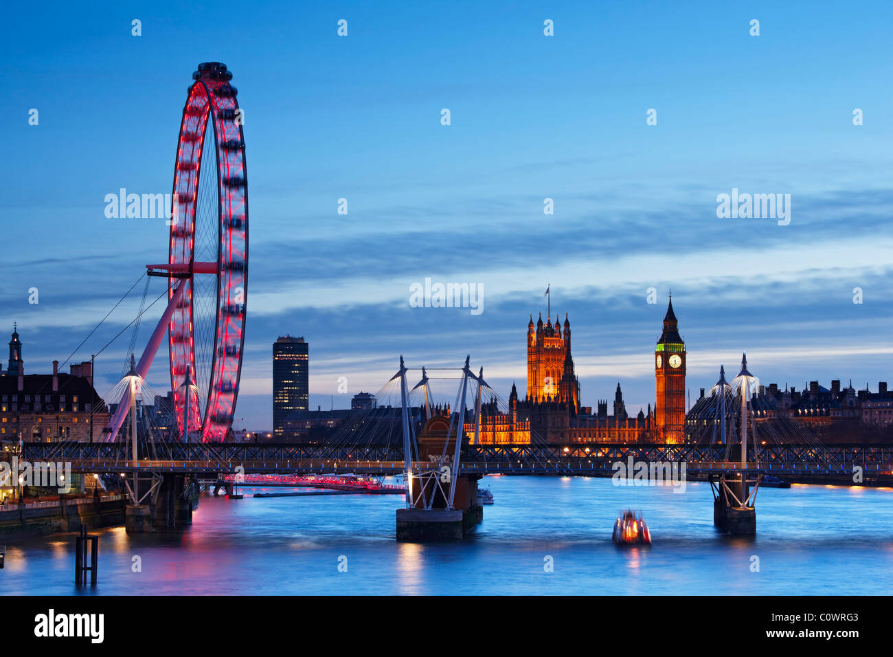 London skyline - views overlooking the River Thames toward The London Eye, the Houses Of Parliament and Jubilee Bridge Stock Photo