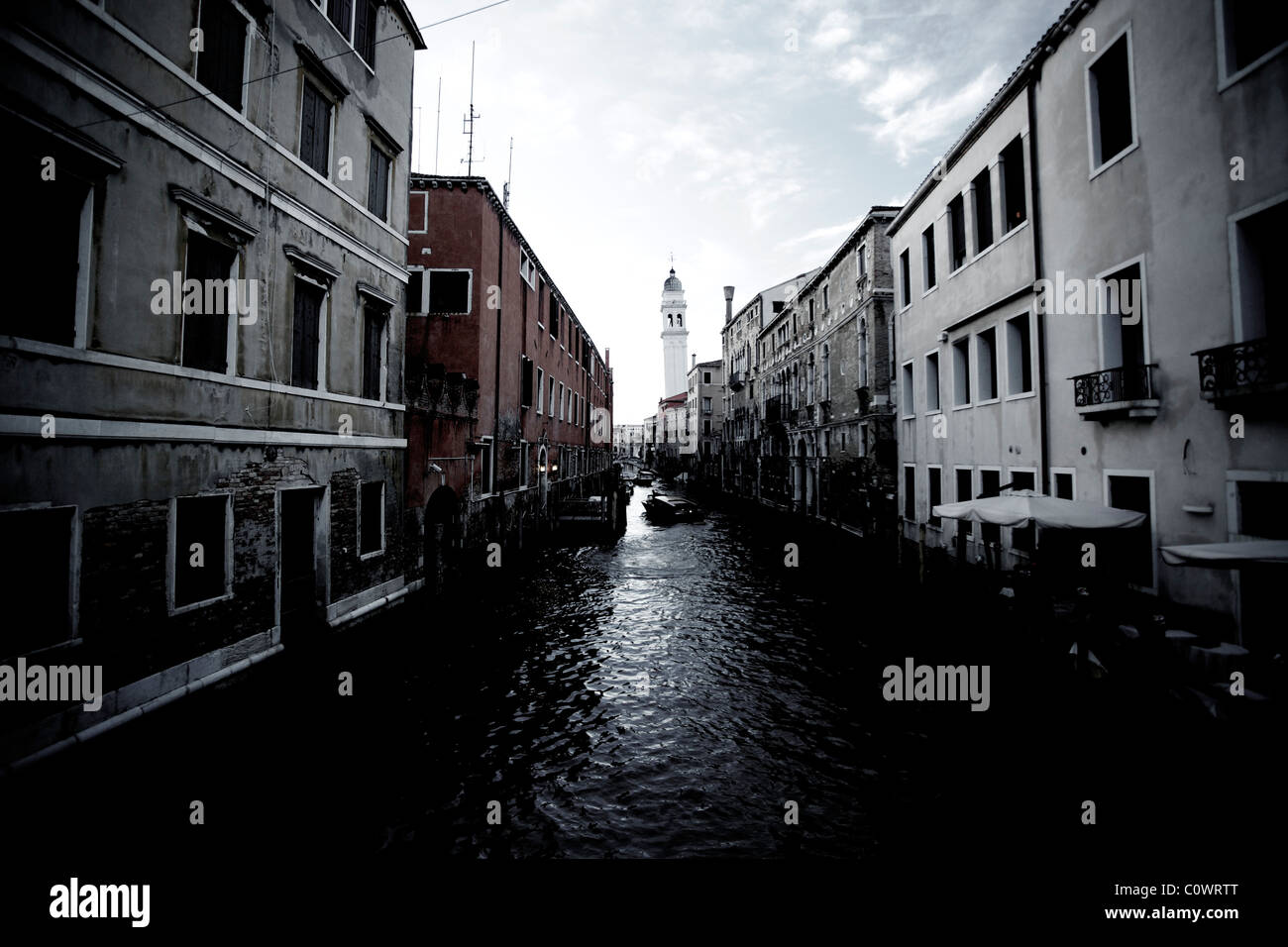 A venetian waterway in Venice Italy with a motorboat taxi commuting on it. Stock Photo