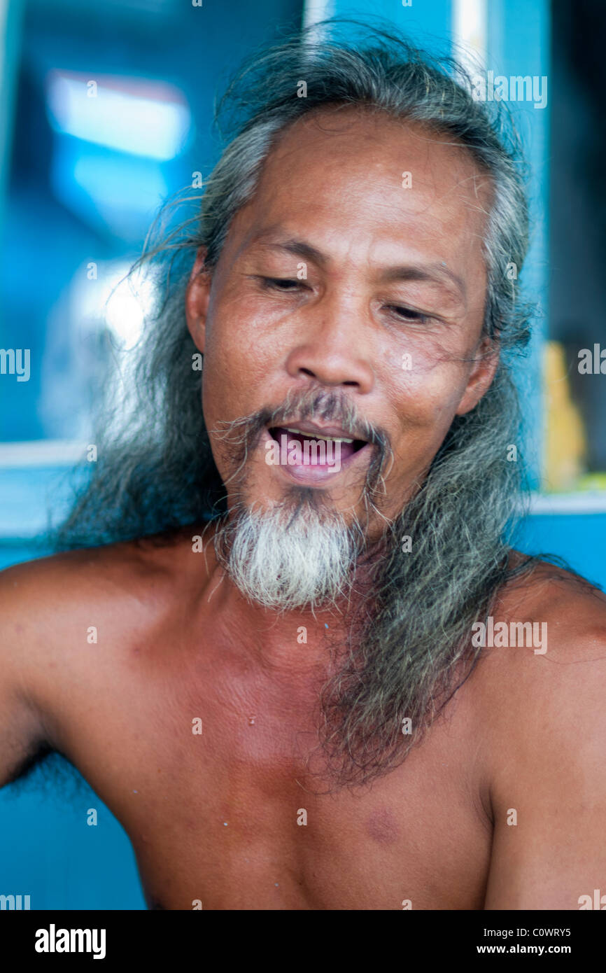 Portrait of a Vietnamese man singing on a boat during a day trip to Nha ...