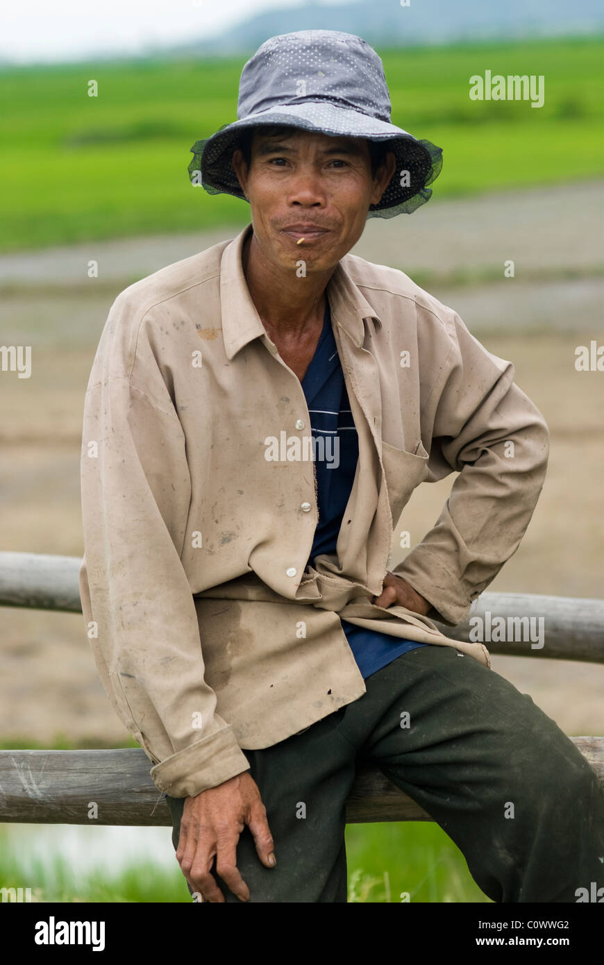 Portrait of a Vietnamese peasant with a rice on his lips Stock Photo Alamy