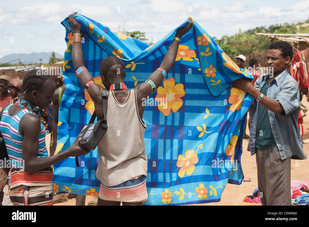 Choosing a blanket at Demeka market, Jinka, Southern Ethiopia Stock