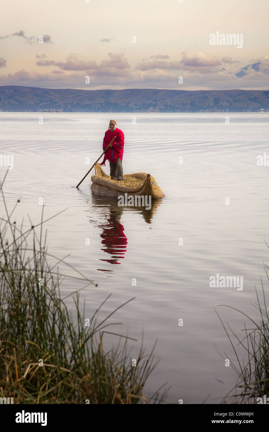 Bolivian man in traditional costume in reed boat on Lake Titicaca, Bolivia, South America. Stock Photo