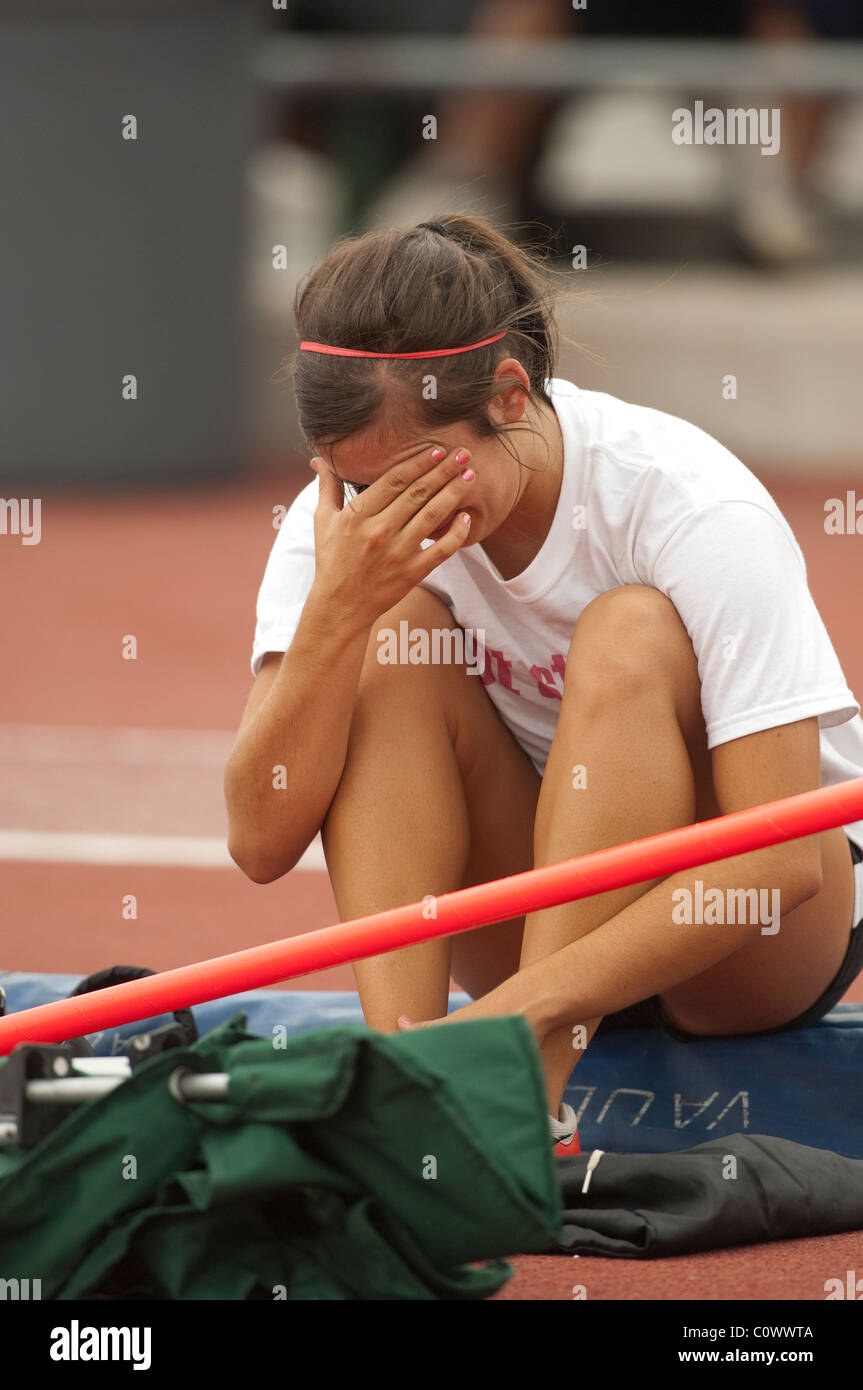 Anglo girl cries after failing to clear the pole vault bar at the Texas high school state track and field meet in Austin Stock Photo