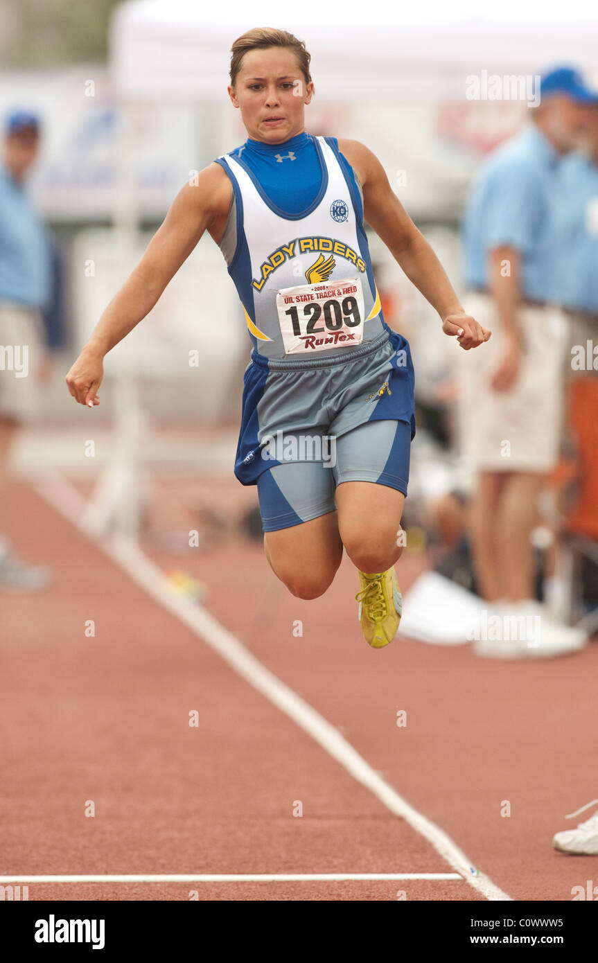 Anglo girl competes in the long jump at the Texas high school state track and field meet in Austin Stock Photo