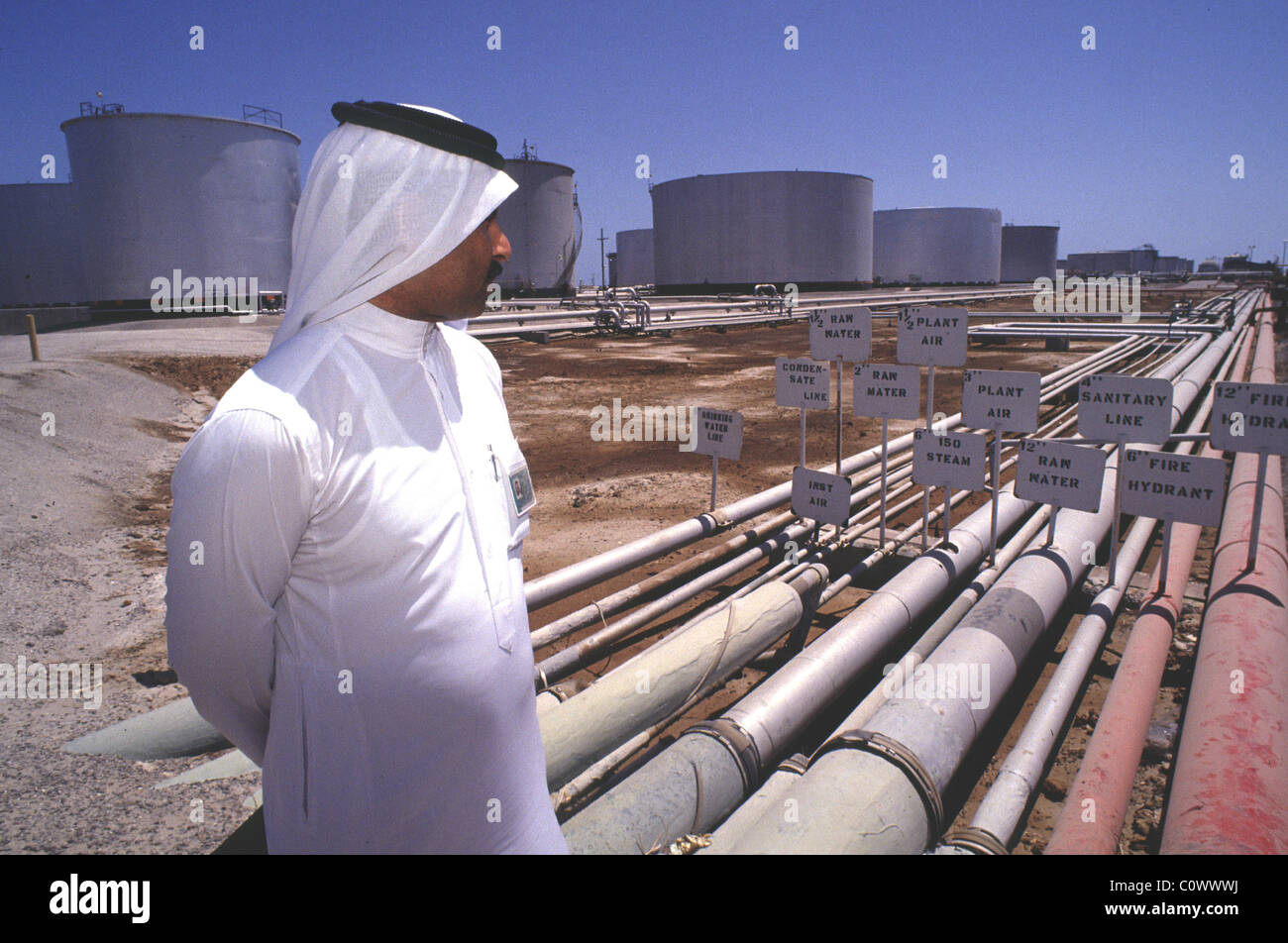 ras tanura, saudi arabia -- a saudi official looks over oil pipelines feeding the largest crude oil refinery in the world. Stock Photo