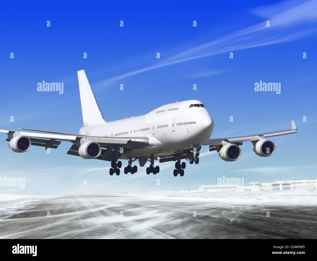 white passenger plane is landing away from airport Stock Photo - Alamy