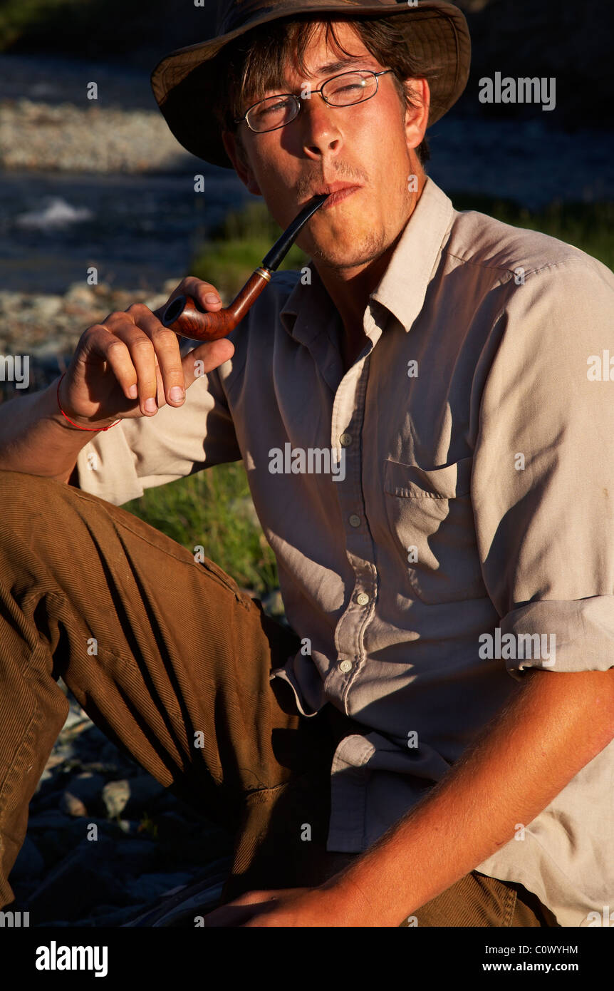 man in hat is smoking tobacco-pipe Stock Photo - Alamy