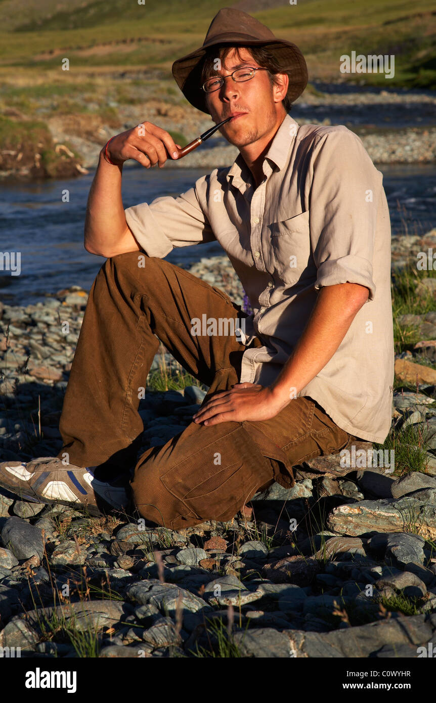 man in hat is smoking tobacco-pipe Stock Photo - Alamy