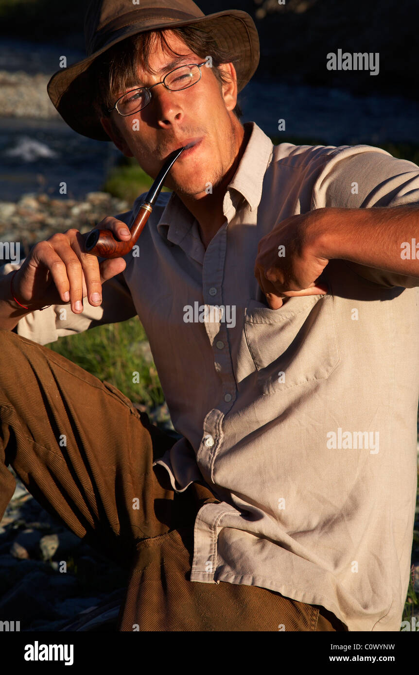man in hat is smoking tobacco-pipe Stock Photo - Alamy