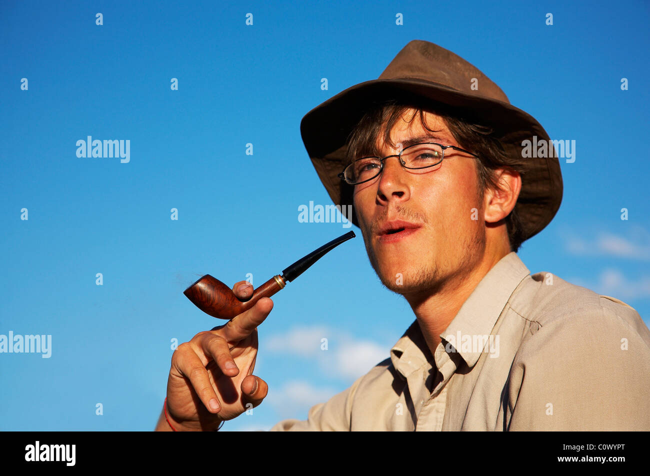 man in hat is smoking tobacco-pipe Stock Photo - Alamy
