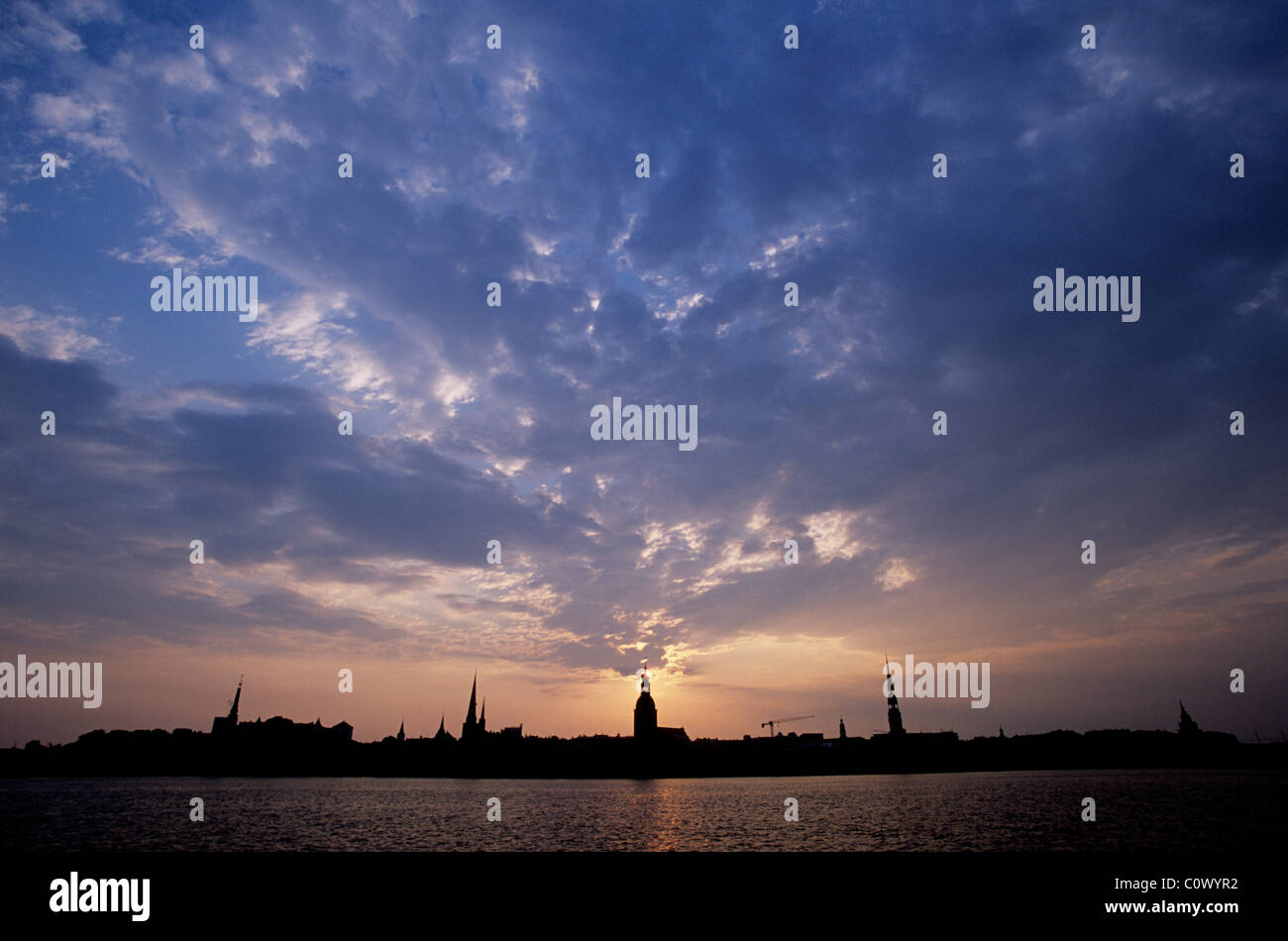 Riga the capital of Latvia, one of the Baltic States. Dawn rises over St Stephens Church on the banks of the Daugava River. Stock Photo