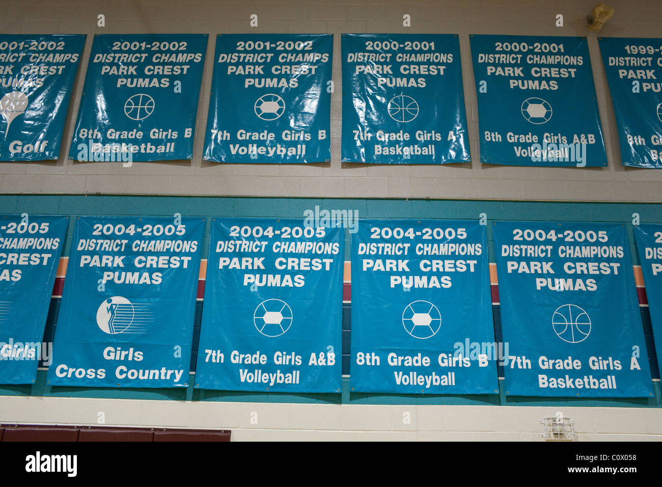 Championship banners for girls sports teams on display in the gymnasium at Park Crest Middle School in Pflugerville Texas Stock Photo