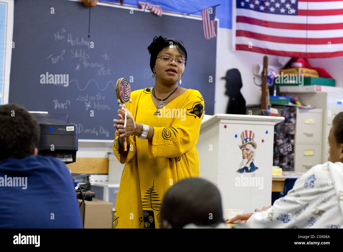 African-American woman in traditional African garb speaks to students during Diversity Day at Park Crest Middle School in Texas Stock Photo