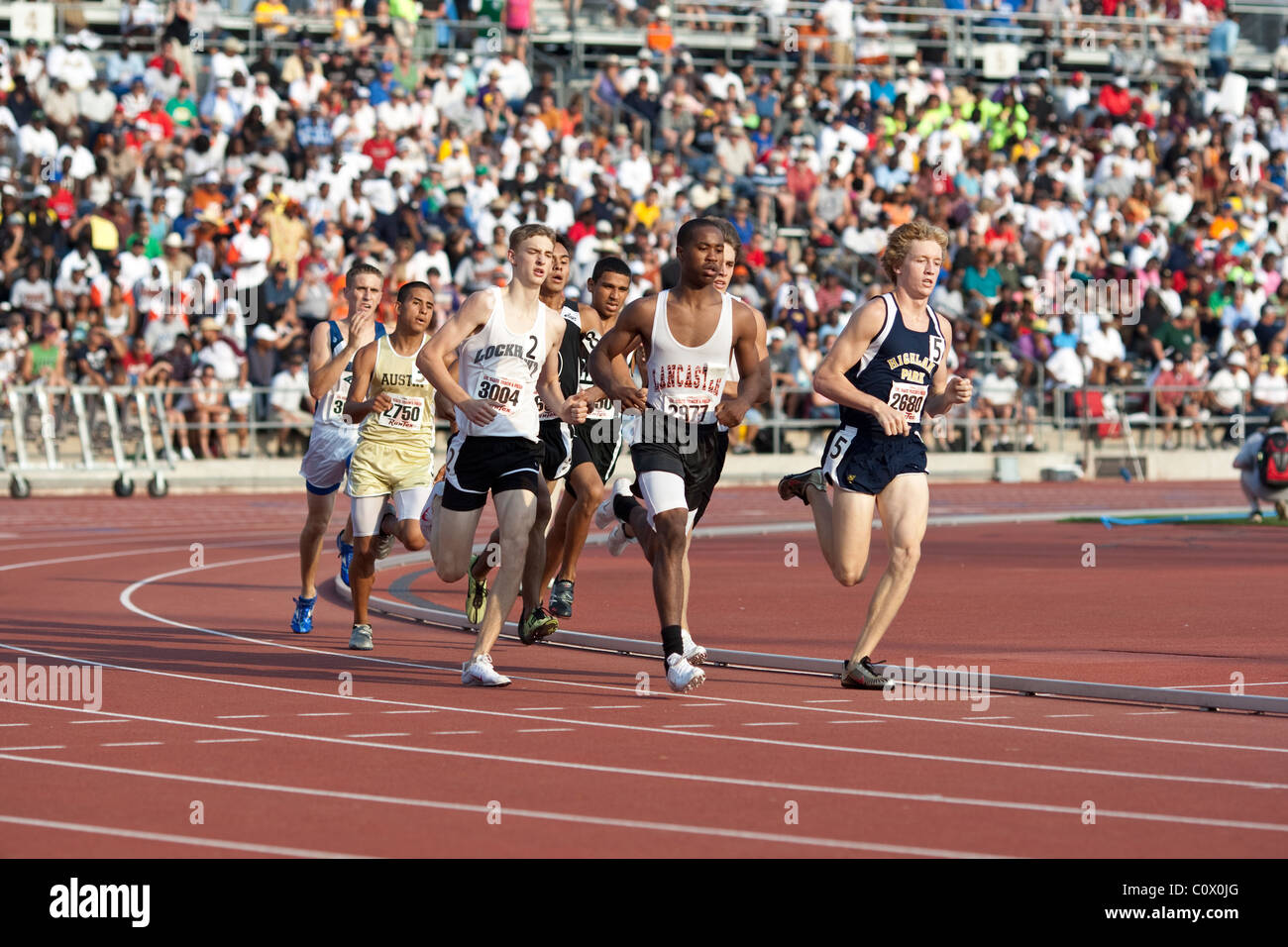 Boys run around the curve in the championship heat of a race at the