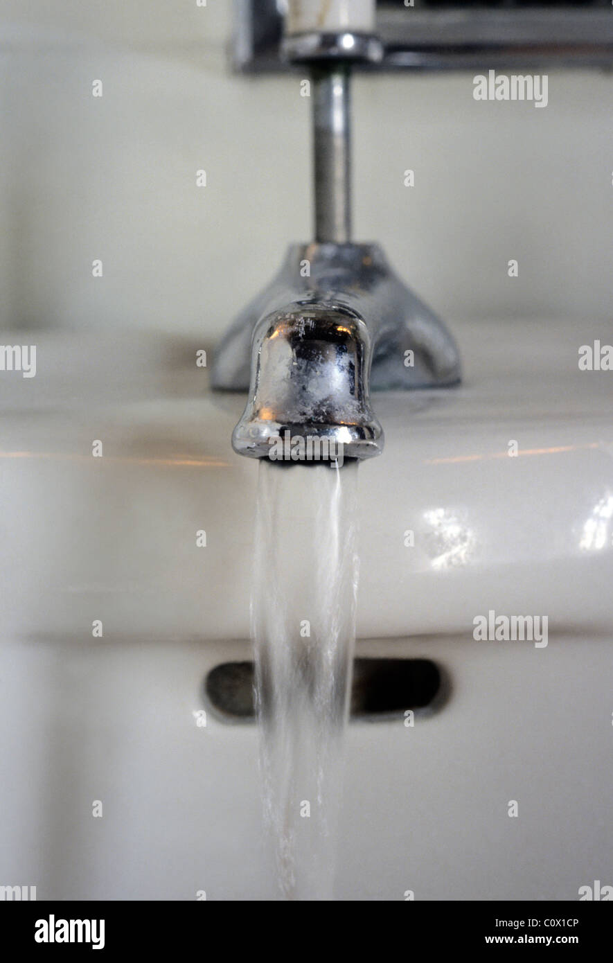 Sink. Washroom faucet running water. Open spigot in a bathroom wash