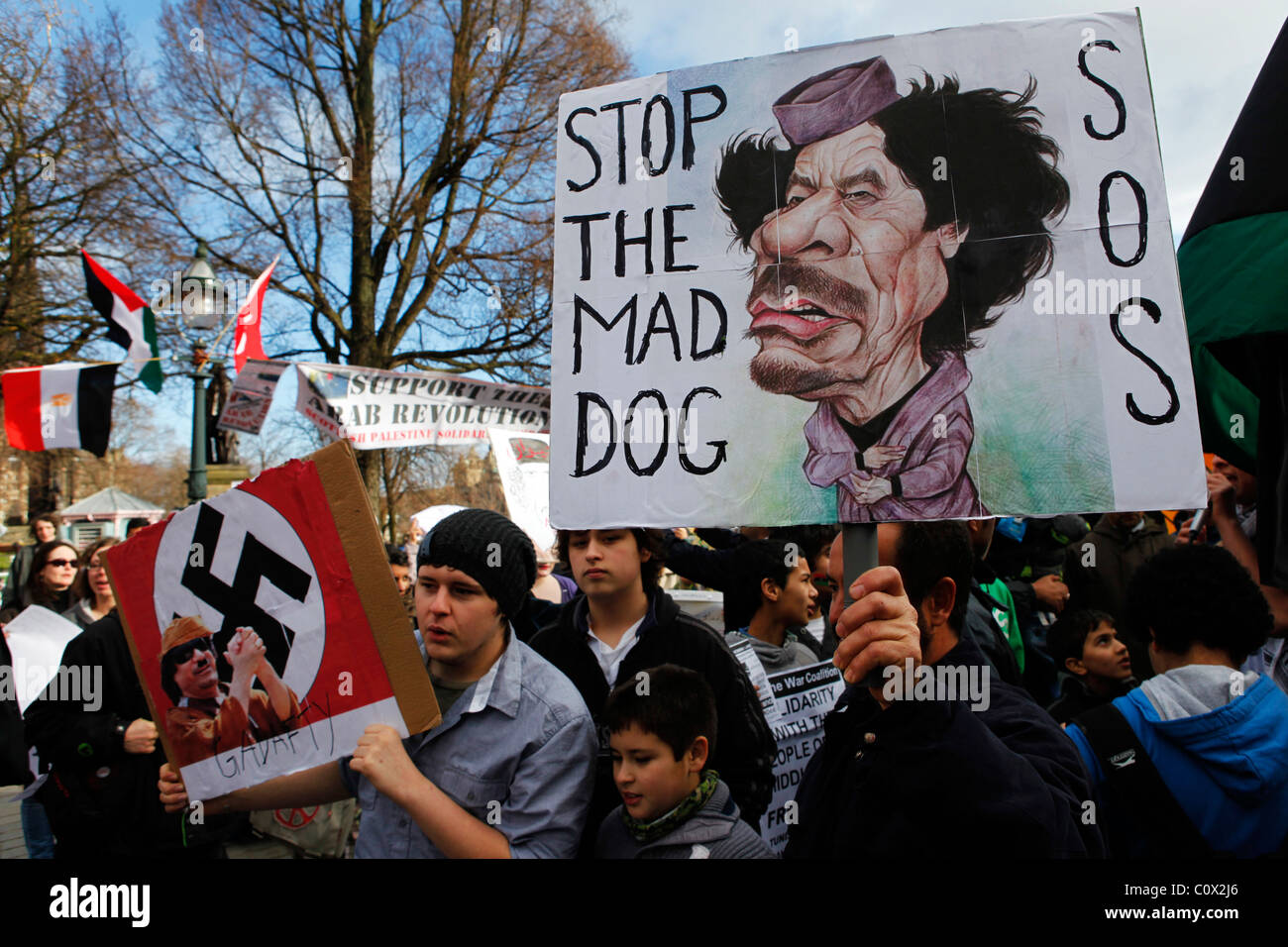 Anti-Gaddafi signs are held up at a demonstration in support of the 2011 Arab revolutions in Edinburgh, Scotland. Stock Photo