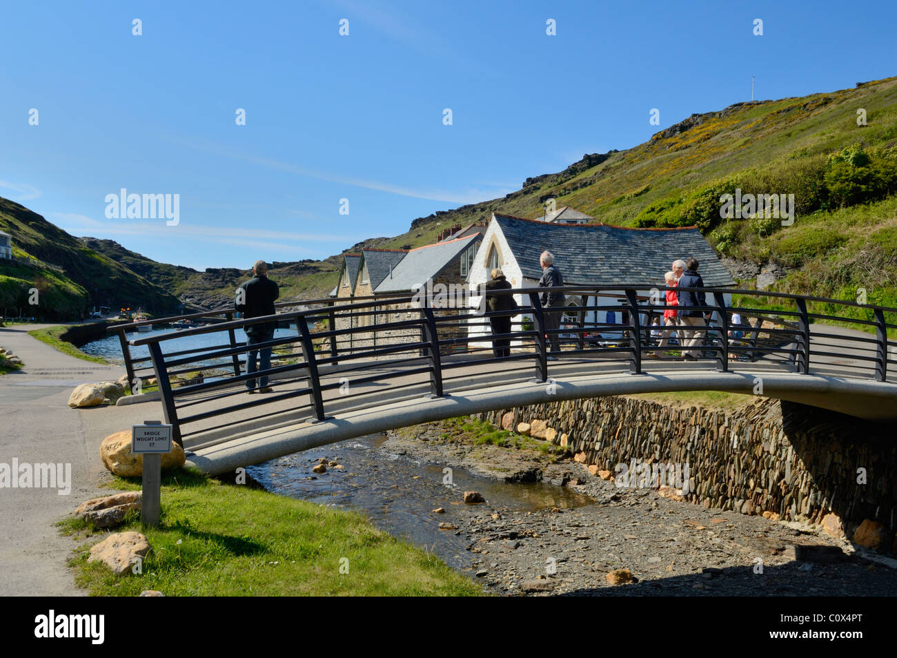 People on the footbridge over the River Valency at Boscastle Harbour, Cornwall, England. Stock Photo